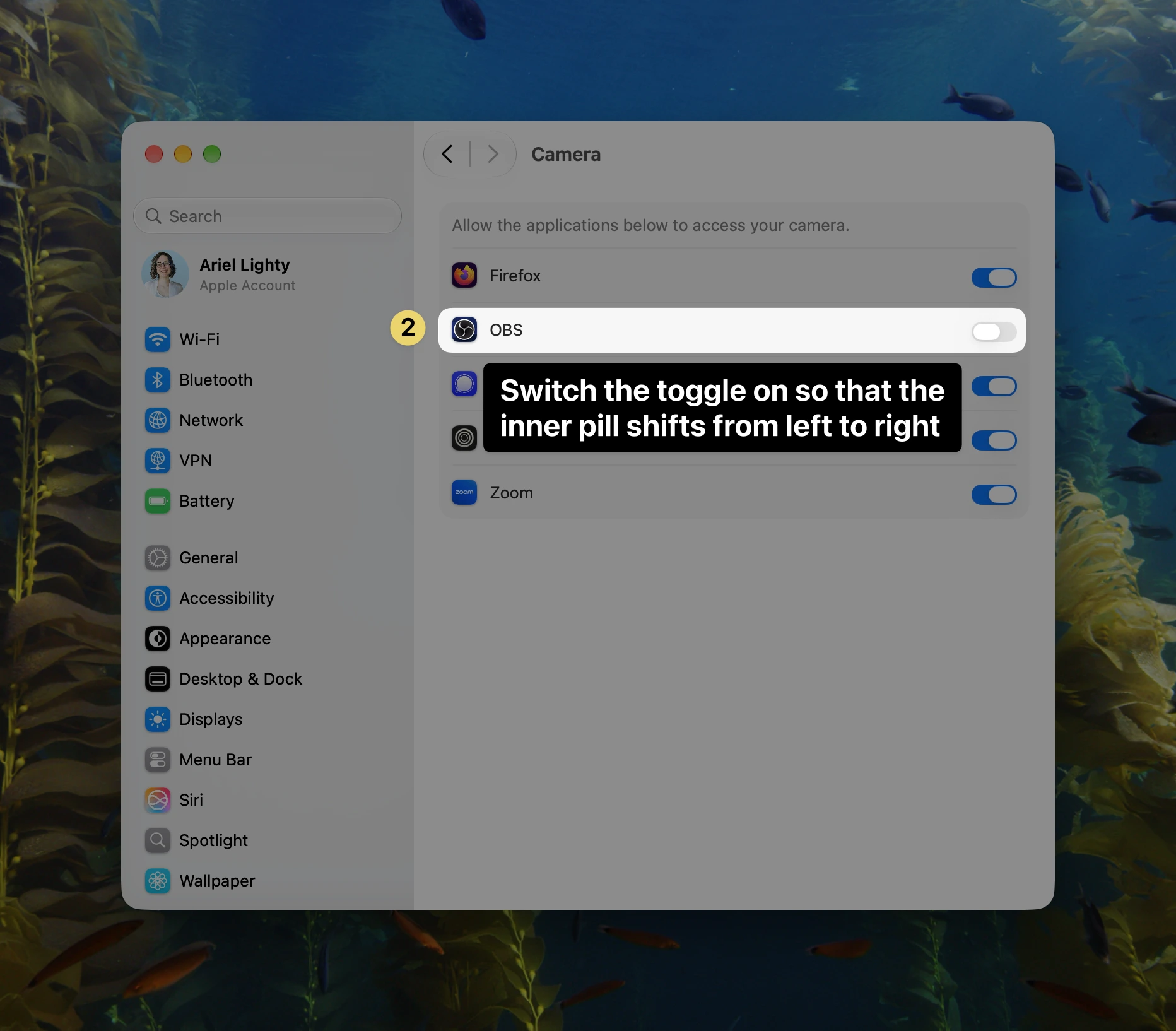 macOS Camera settings window highlighting the OBS permission toggle with an instruction callout to switch the toggle on.