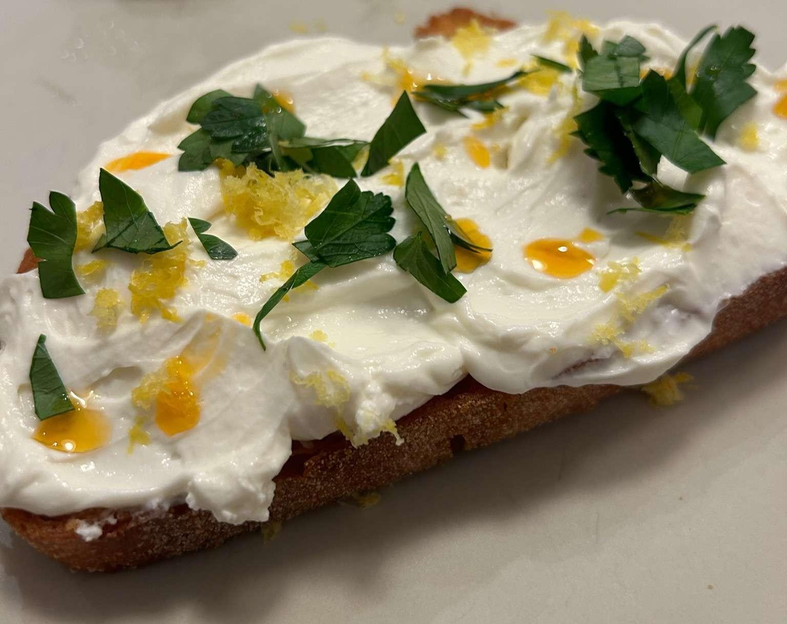 Whipped ricotta on fried bread with parsley, chili oil, and lemon zest