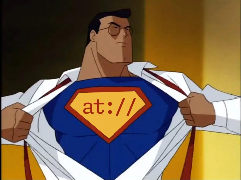 Superman, from the cartoon, pulling his shirt off but instead of "S" his super-suit says "at://"